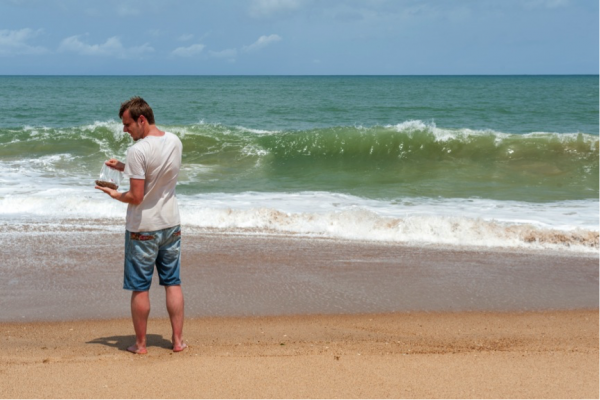 Benni taking a sample from the beach face for later heavy mineral analysis. Photo TM Benni taking a sample from the beach face for later heavy mineral analysis. Photo TM
