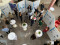 A group of people are gathered in a bright indoor atrium for a professional event or conference. A group of people are gathered in a bright indoor atrium for a professional event or conference.
