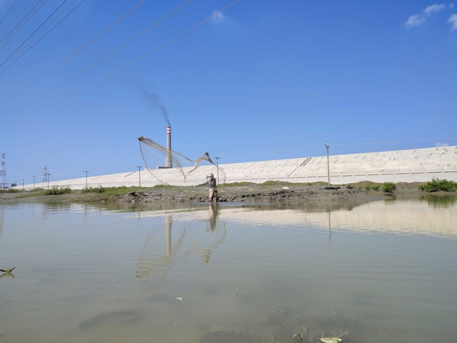 Small-scale fisher on a canal along a coal power plant in Maheshkhali island, Bangladesh | Photo: M. Govender