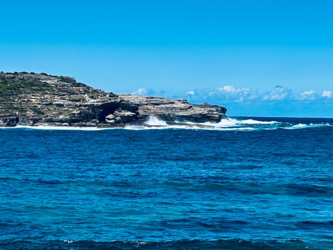 Sea waves crash against a rocky coast